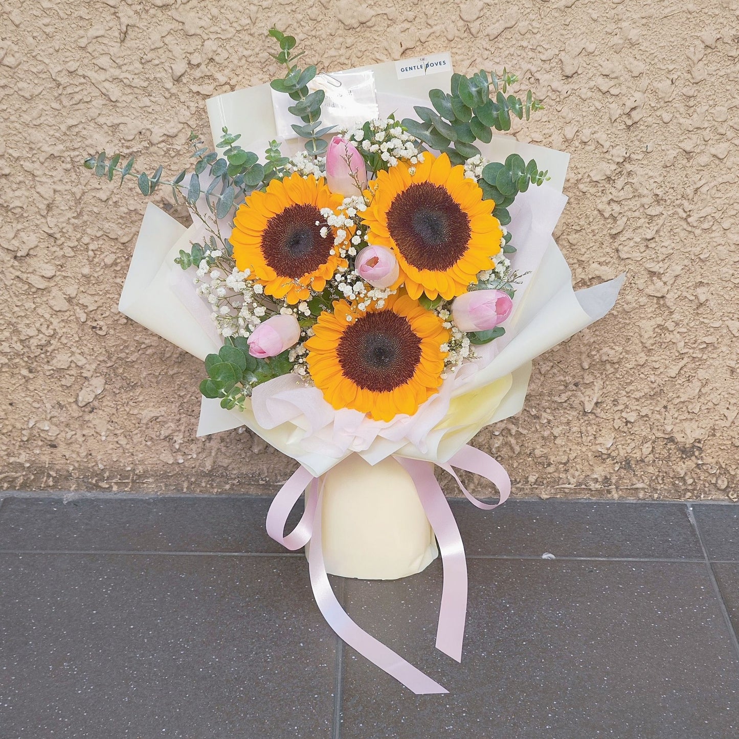 Three Sunflowers with Four Soft Pink Tulips and Filler Flowers Bouquet