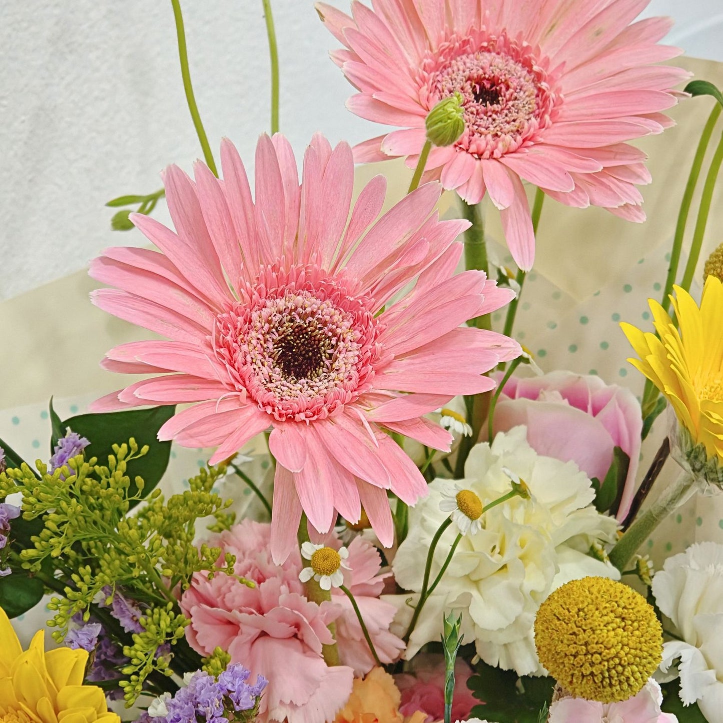 Assorted Pastel and Colorful Flowers in Soft Yellow Bouquet