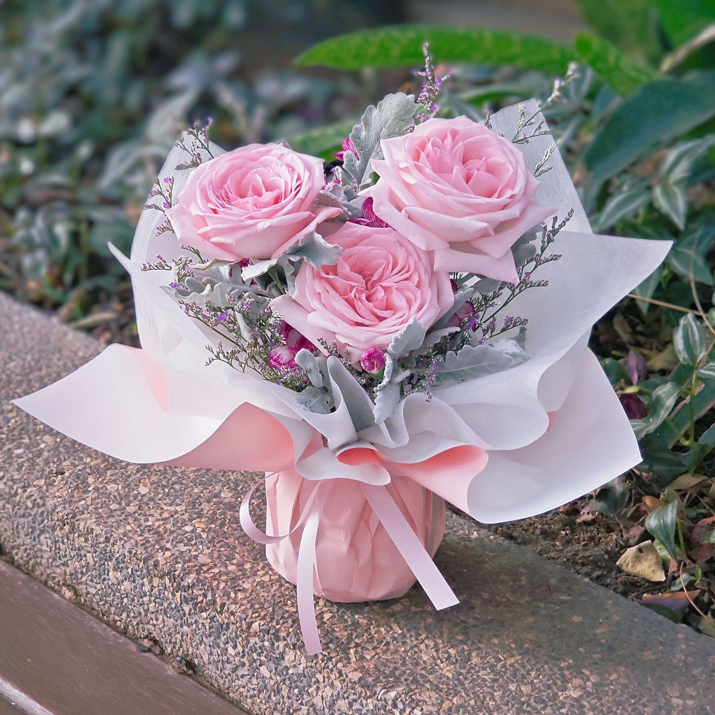 Three Soft Pink English Roses with Filler Flowers in Small Vase Arrangement