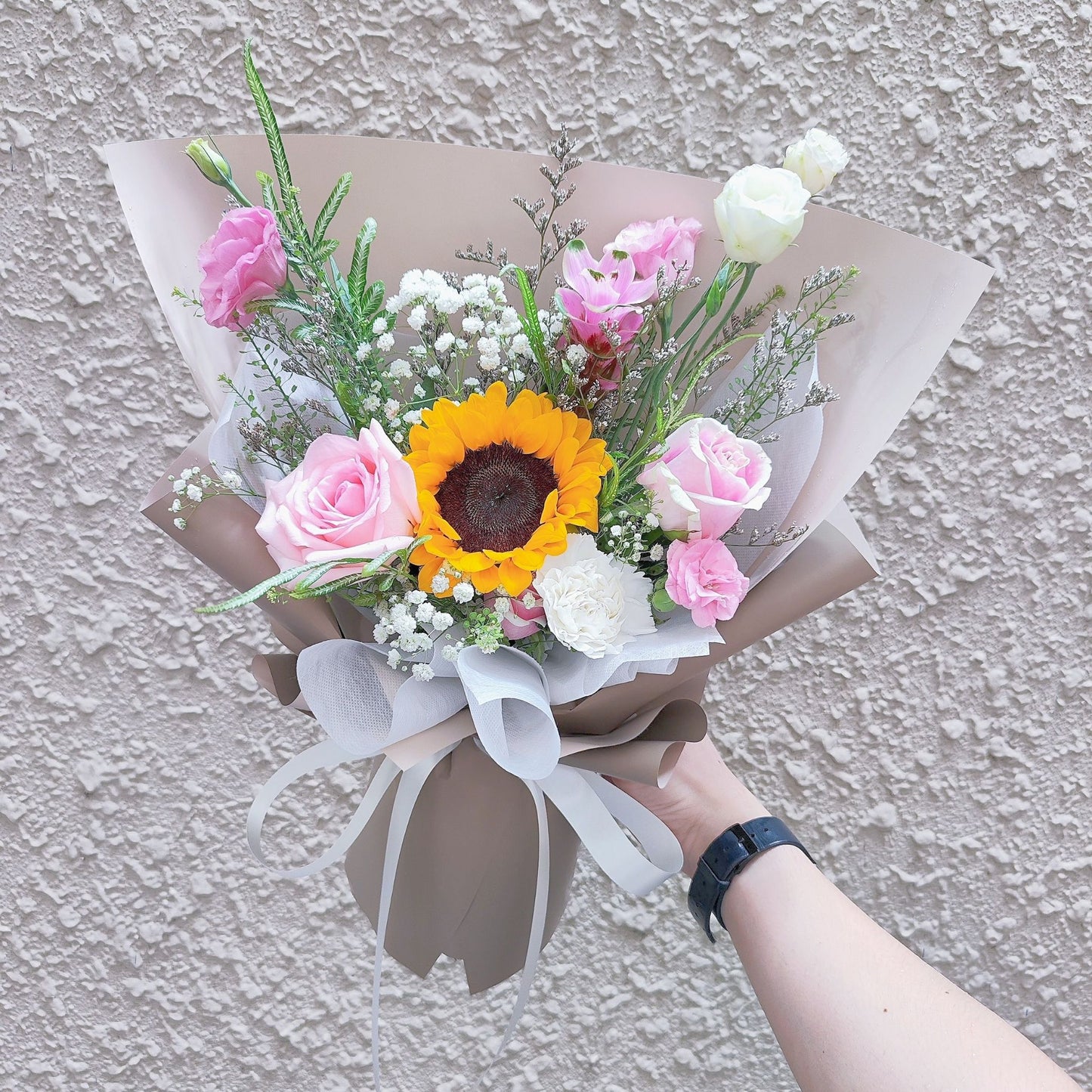 Single Sunflower with Pink Flowers and Foliage in Brown Paper Bouquet