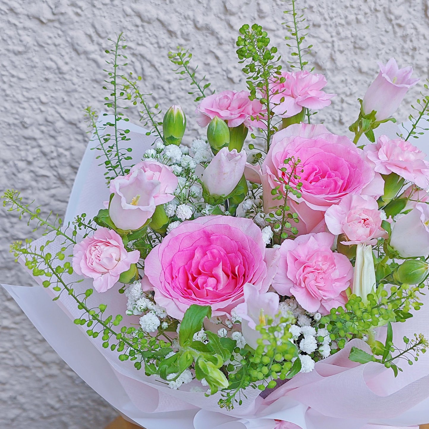 Soft Pink Roses with Assorted Pink Flowers and Green Foliage in Small Vase Arrangement.