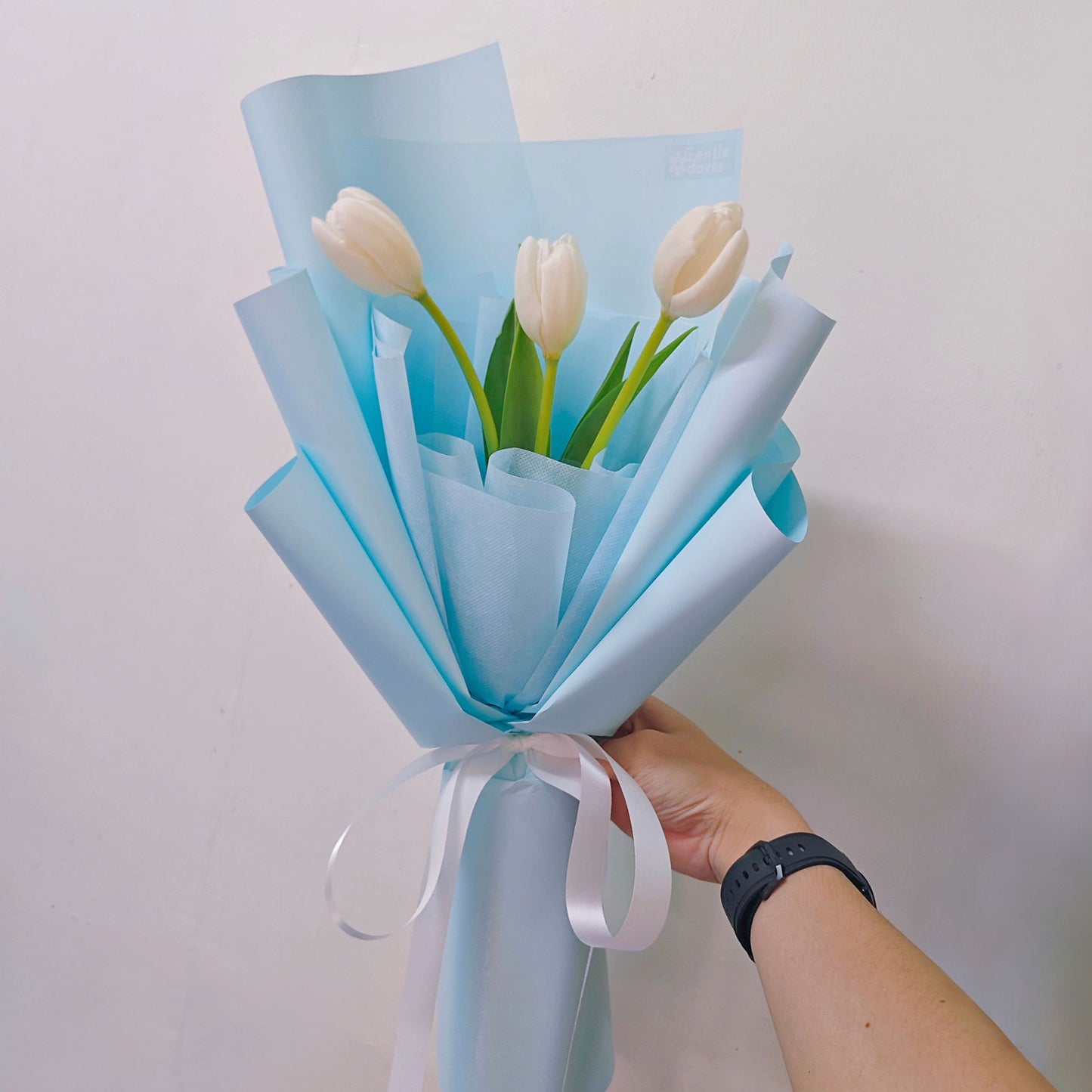 Three White Tulips in Soft Blue Paper Bouquet