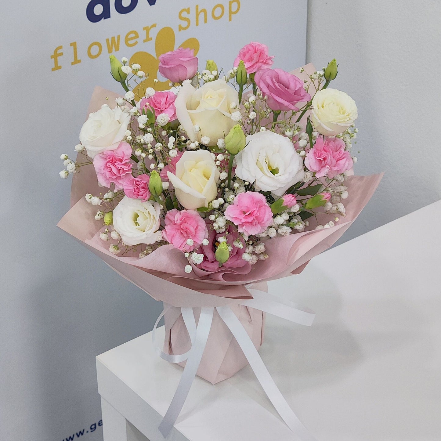 Assorted Pink Sprayed Carnations, lisianthus and White Roses in Small Vase Arrangement