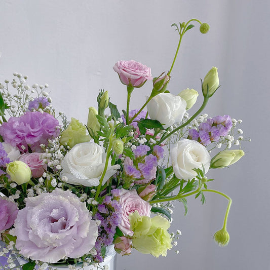 Assorted Pastel Purple Flowers in Small Box Arrangement