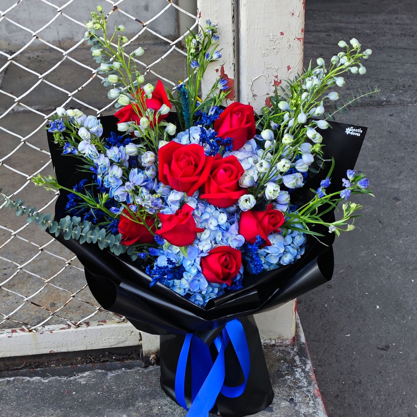 Assorted Blue Flowers and Red Roses in Black Paper Large Bouquet