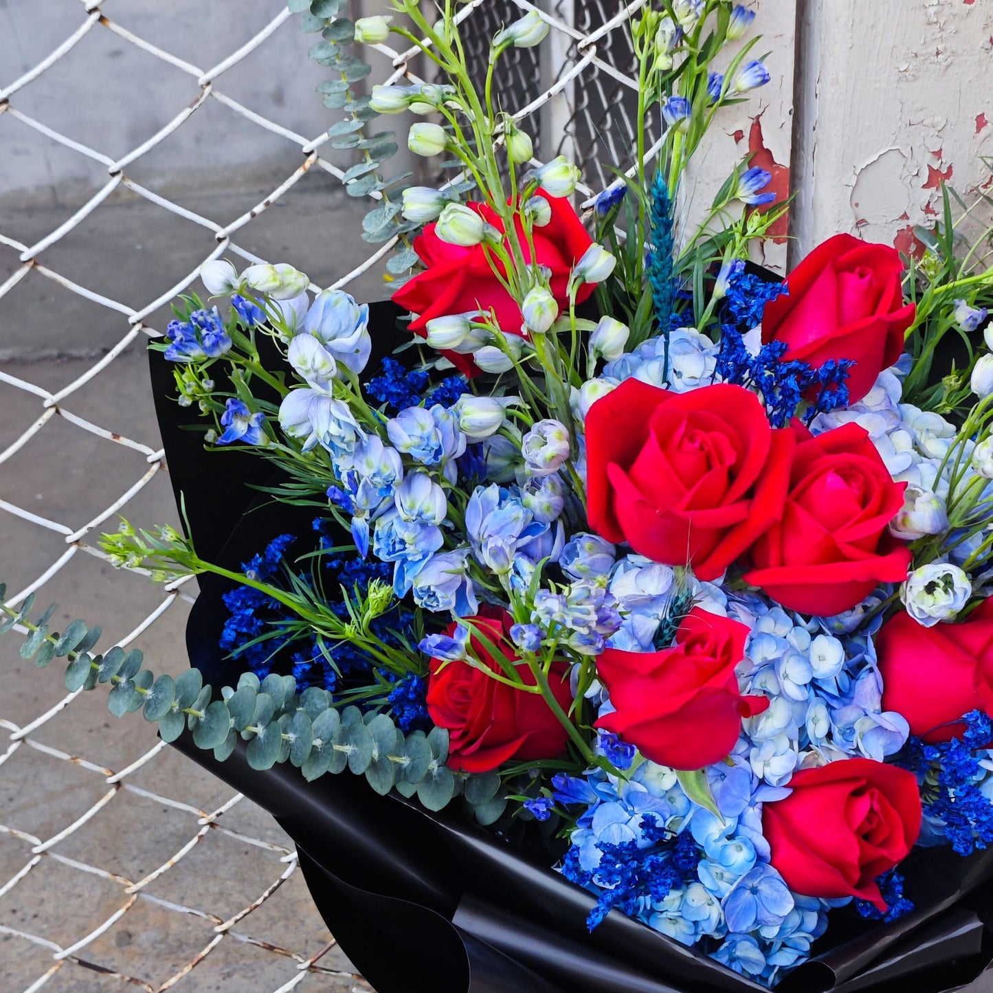 Assorted Blue Flowers and Red Roses in Black Paper Large Bouquet