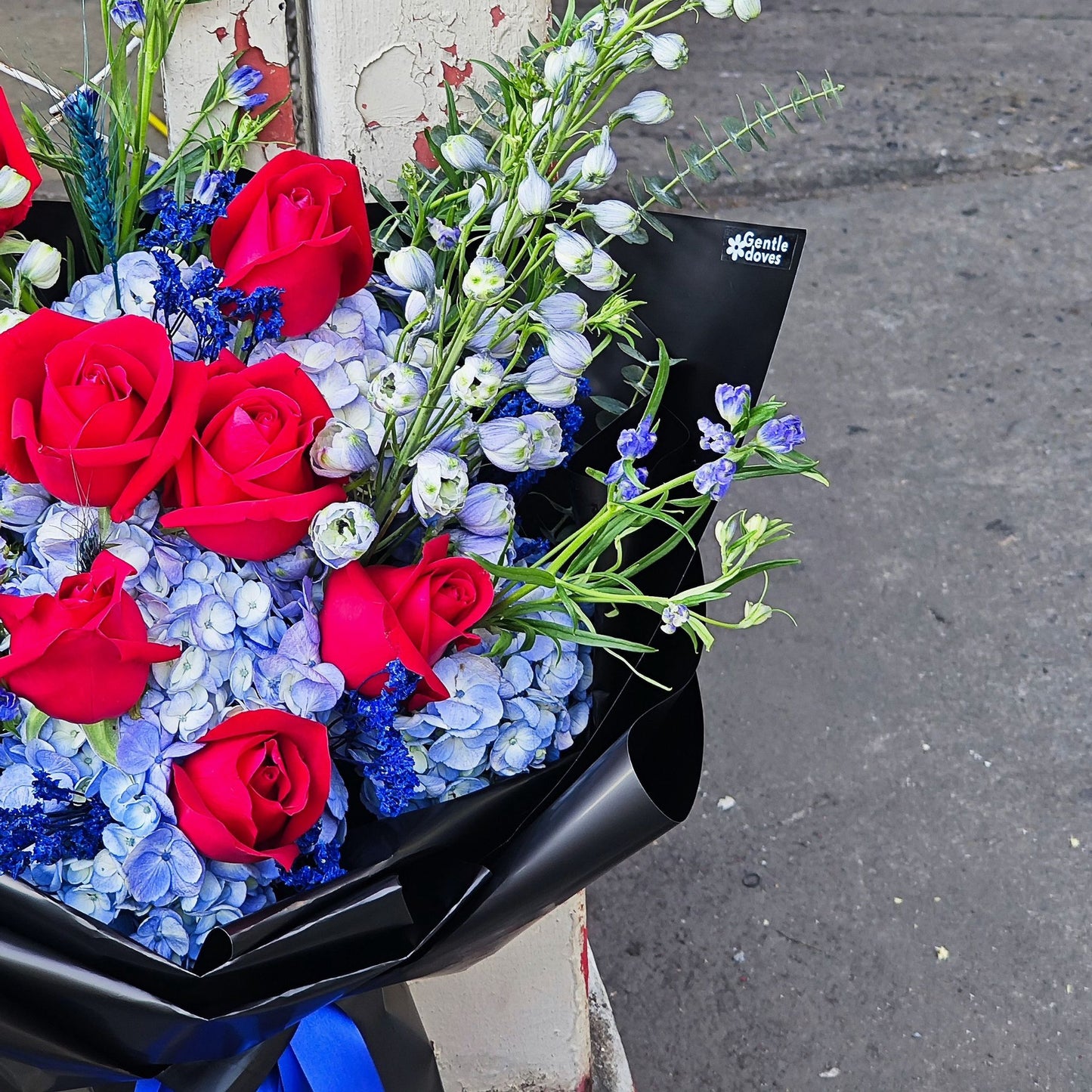 Assorted Blue Flowers and Red Roses in Black Paper Large Bouquet