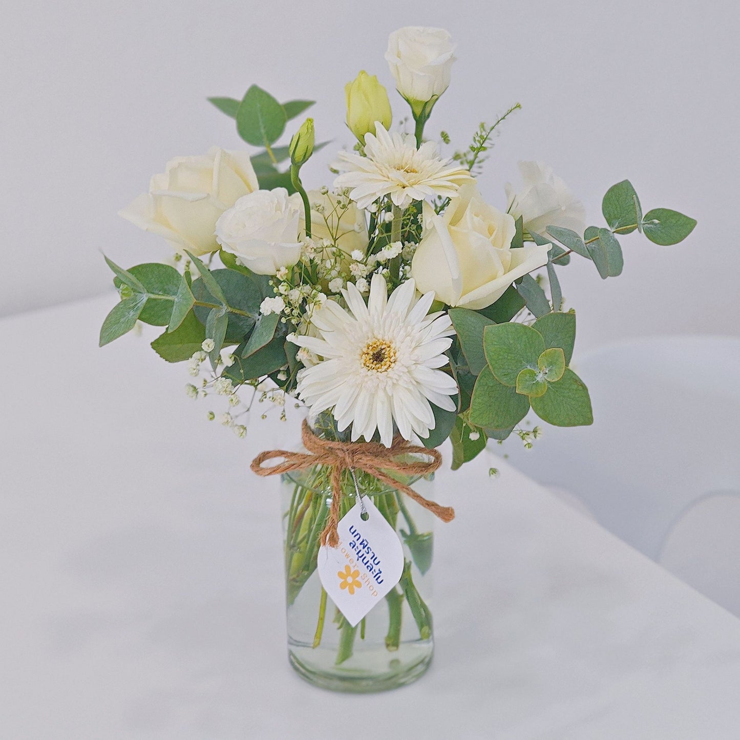 Assorted White Roses and Gerberas with Green Foliage in Small Vase Arrangement