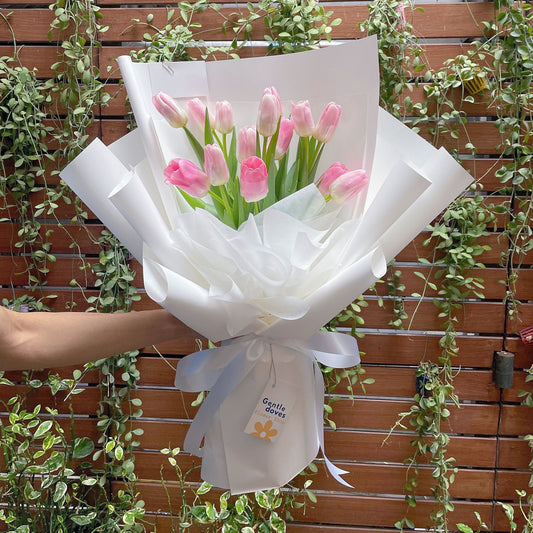 Fourteen Soft Pink Tulips in White Paper Bouquet