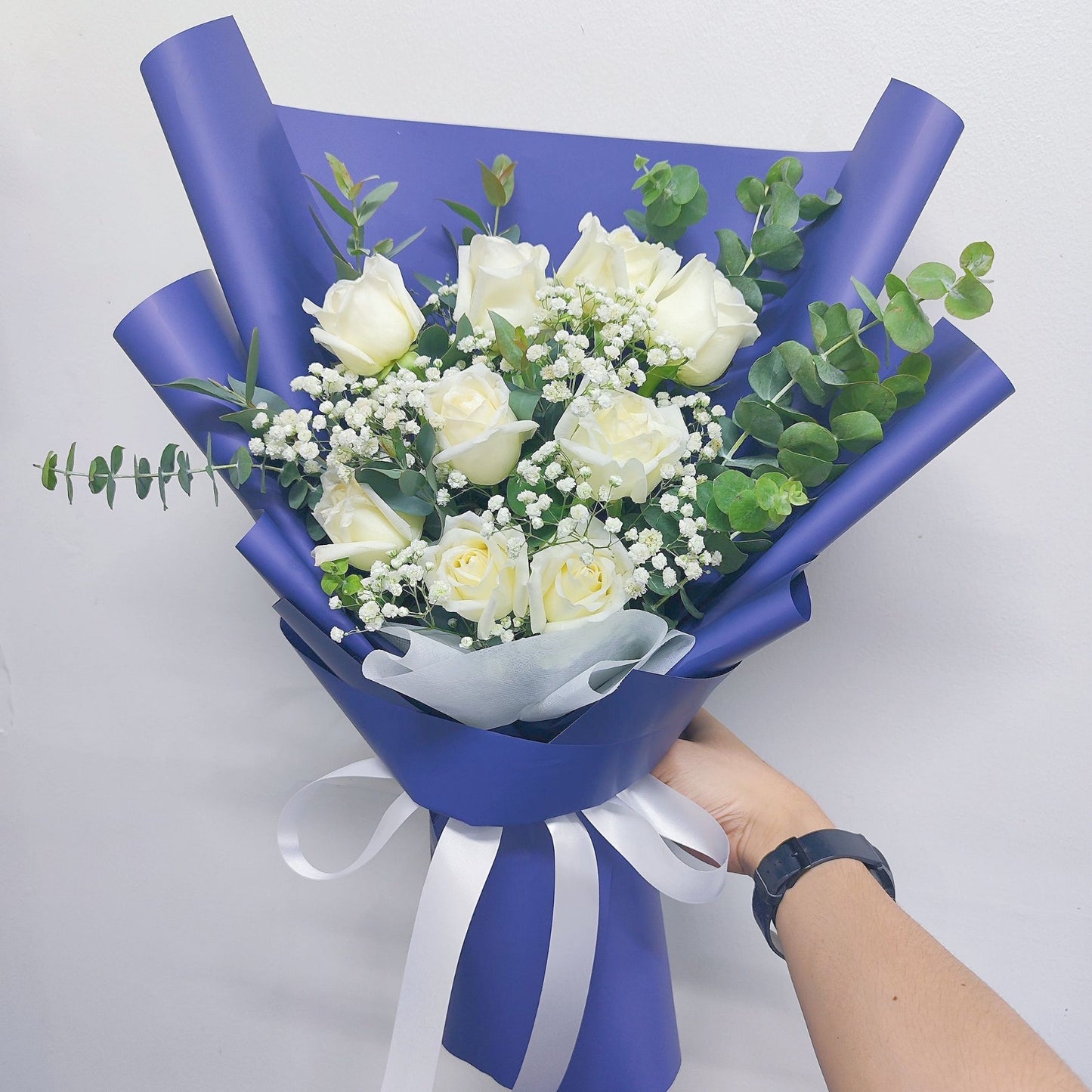 Nine White Roses with Eucalyptus and Gypsophila in Blue Paper Bouquet