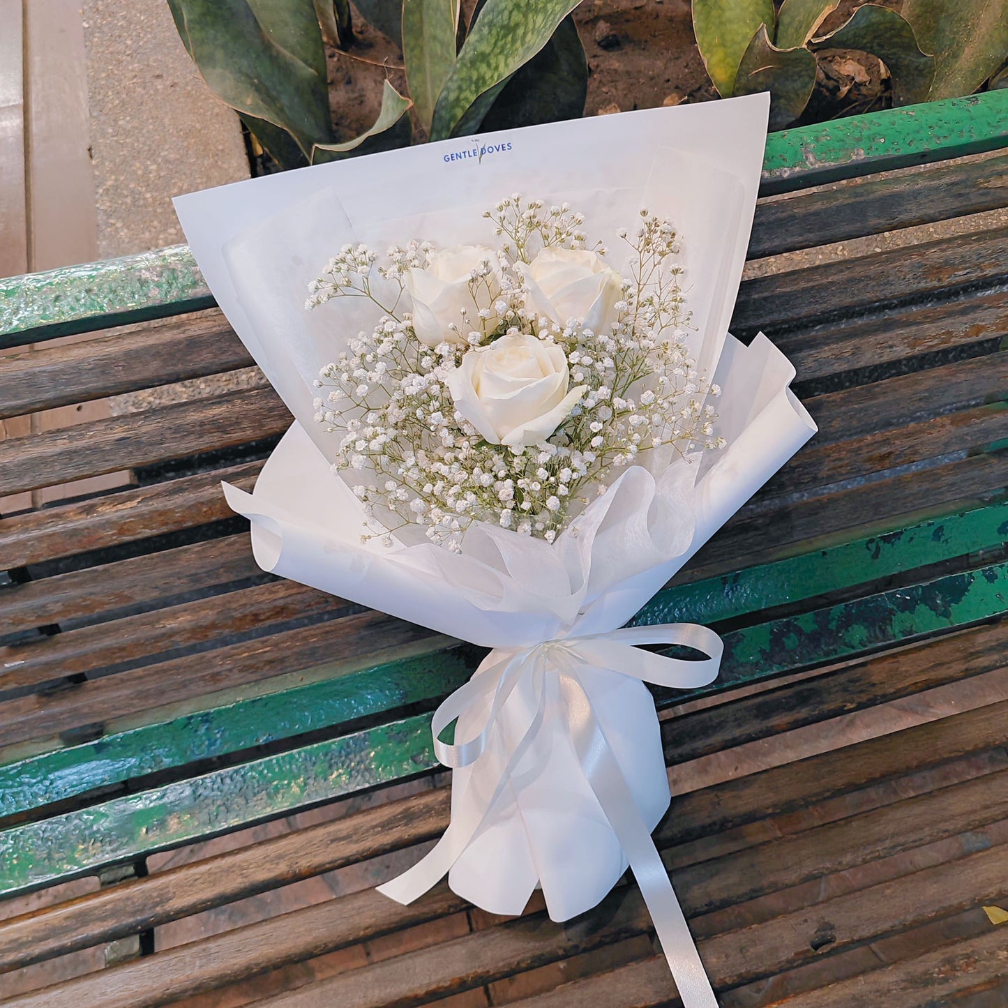 Three Imported White Roses with Gypsophila in White Paper Bouquet