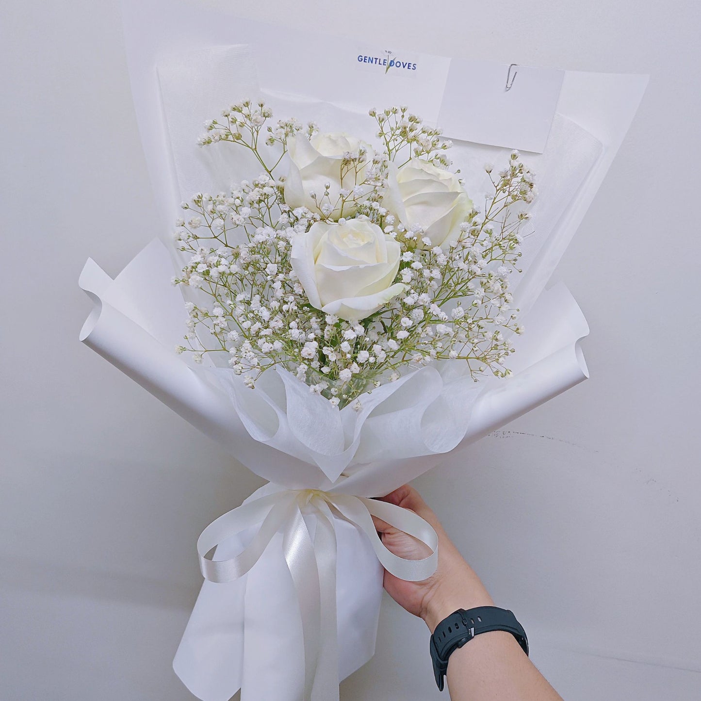 Three Imported White Roses with Gypsophila in White Paper Bouquet
