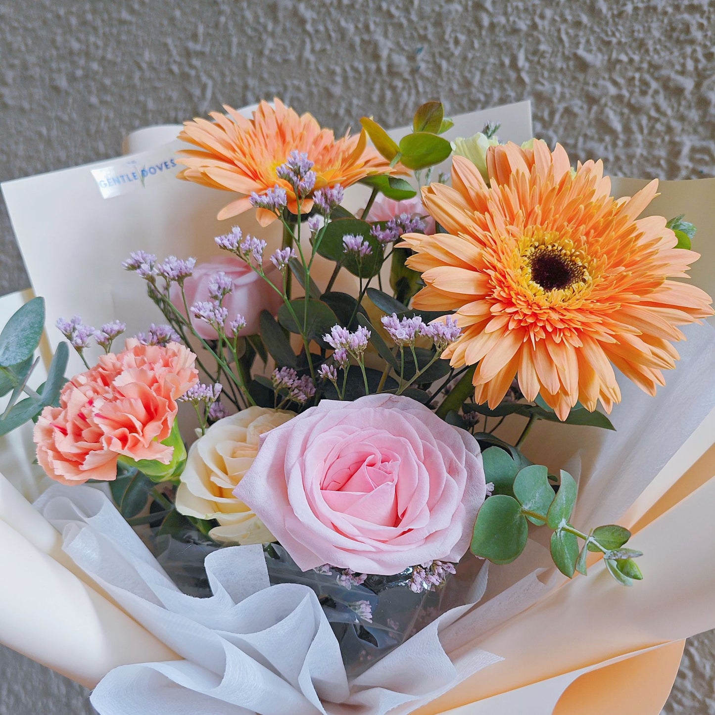 Assorted Soft Yellow-Orange and Pink Flowers in Soft Yellow Paper Small Bouquet