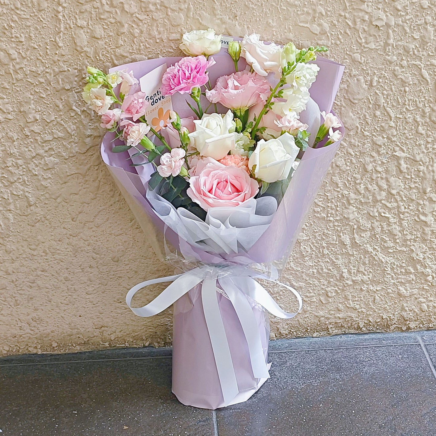 Assorted Soft Pink and White Flowers in Soft Purple Paper Bouquet