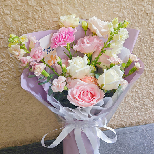 Assorted Soft Pink and White Flowers in Soft Purple Paper Bouquet