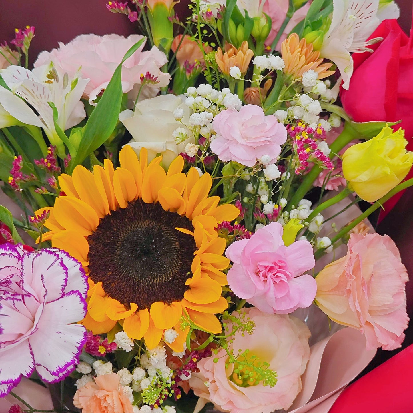 Assorted Vivid and Colorful Flowers in Red Paper Bouquet