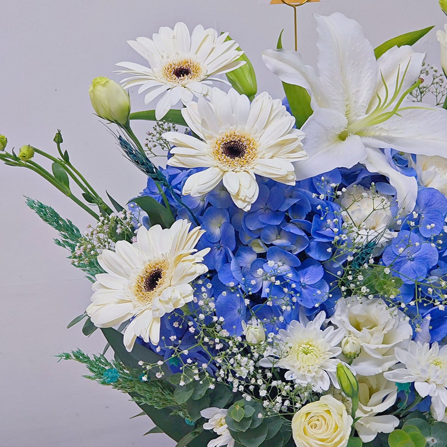 Assorted Blue and White Flowers in Medium Ceramic Vase Arrangement