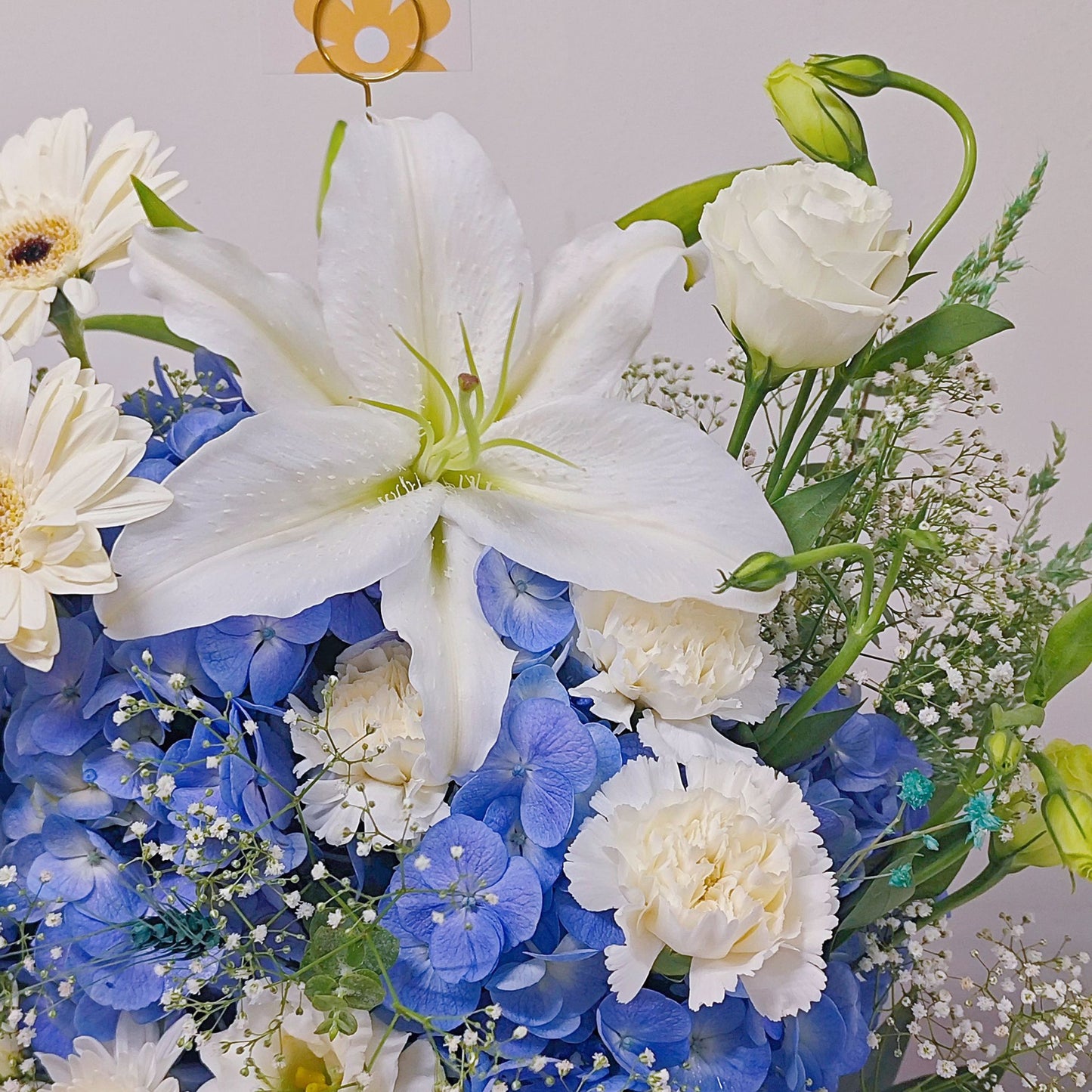 Assorted Blue and White Flowers in Medium Ceramic Vase Arrangement