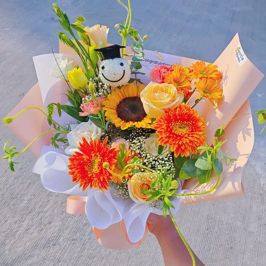 Assorted Orange and Yellow Flowers with Graduated Smiley Face Bouquet