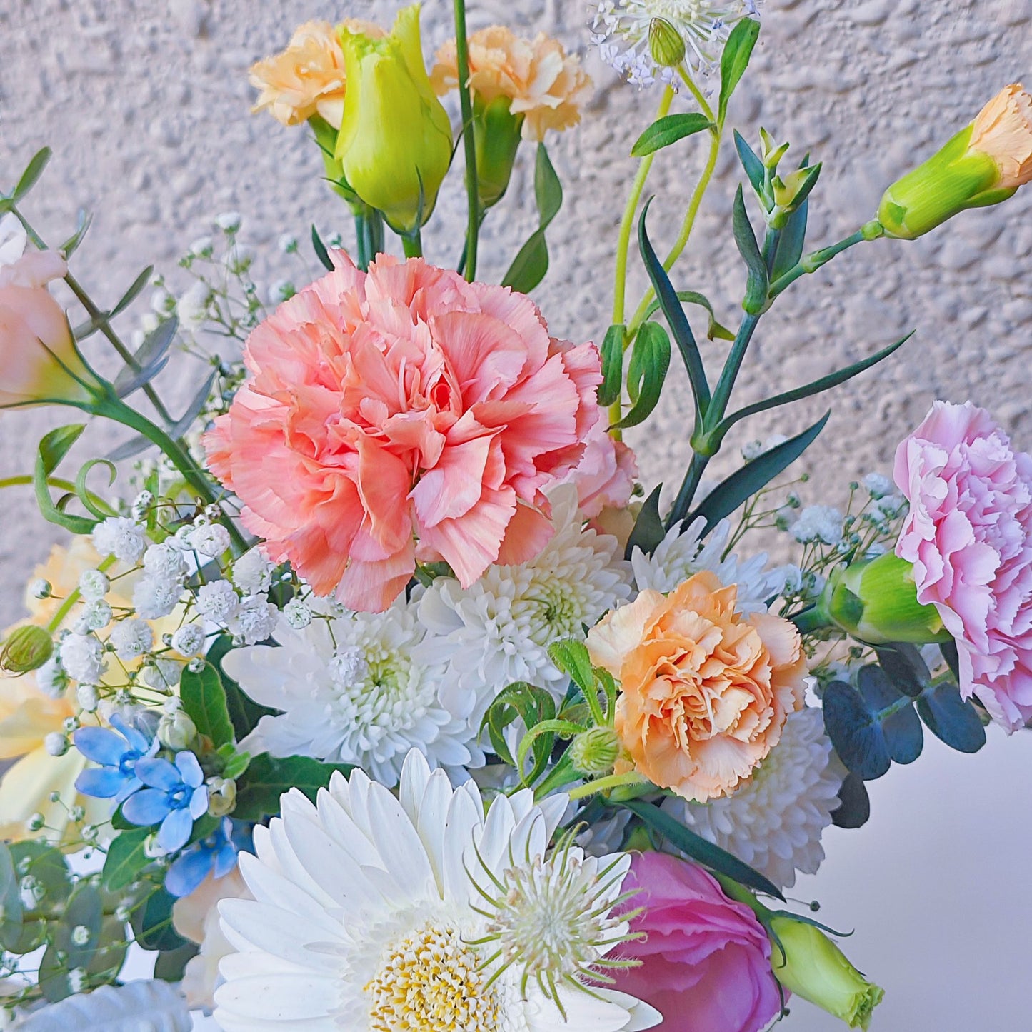 Assorted Soft Tone Flowers and Foliage in Medium Vase Arrangement