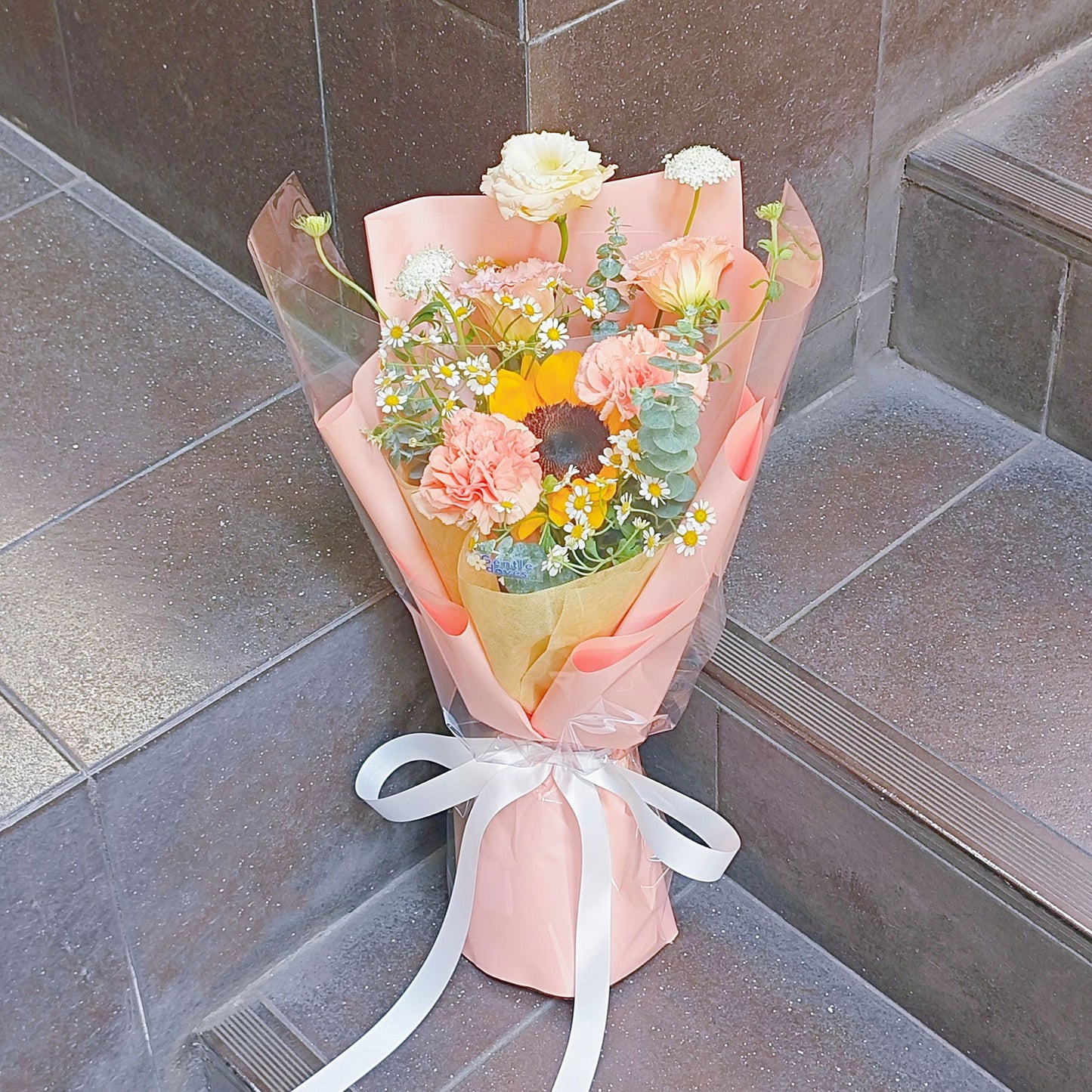 Single Sunflower with Assorted Orange Flowers in Medium Size Orange Paper Bouquet