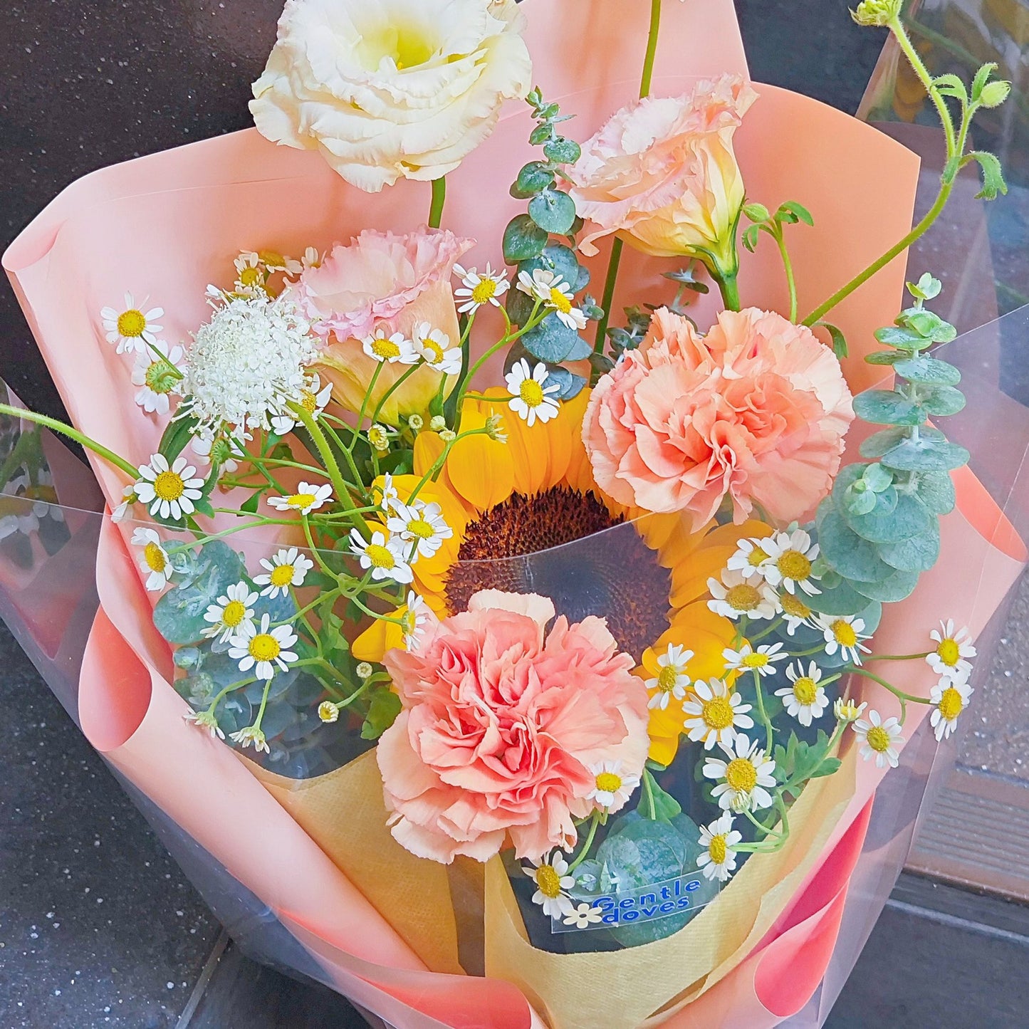 Single Sunflower with Assorted Orange Flowers in Medium Size Orange Paper Bouquet