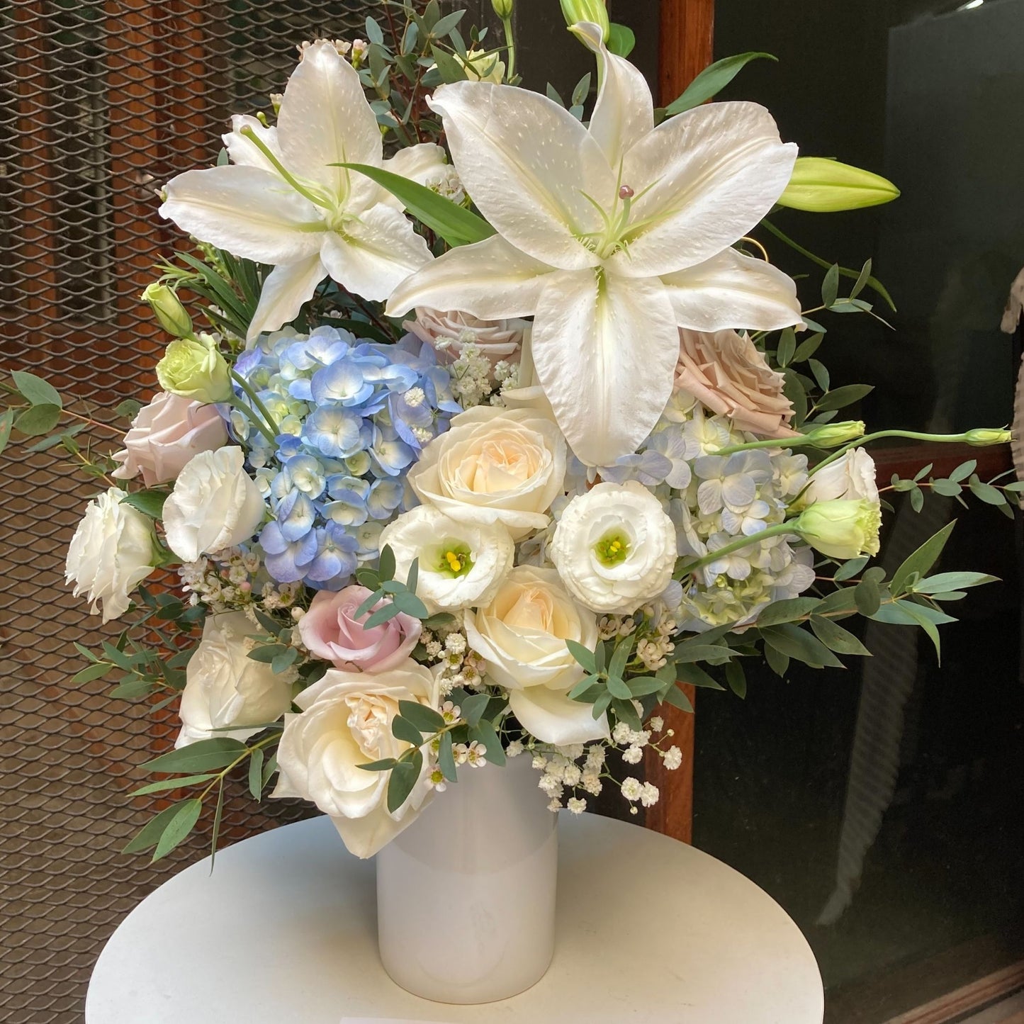 Assorted Soft Tone Flowers in Medium Ceramic Vase Arrangement
