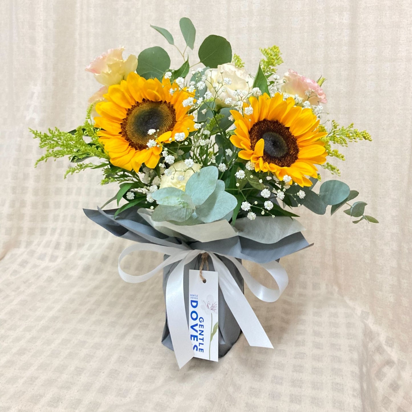 Two Sunflowers with Lisianthus and Green Foliage in Medium Vase Arrangement