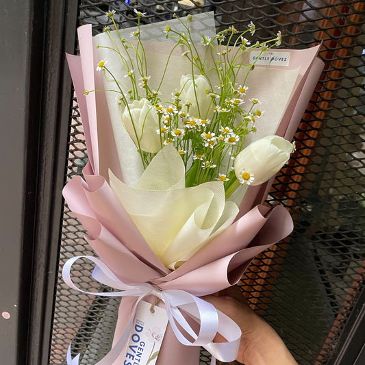 Three White Tulips with Daisies in Pink Paper Bouquet