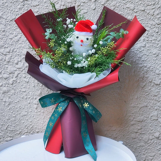 Santa with Green Foliage and Gypsophila in Red Paper Bouquet