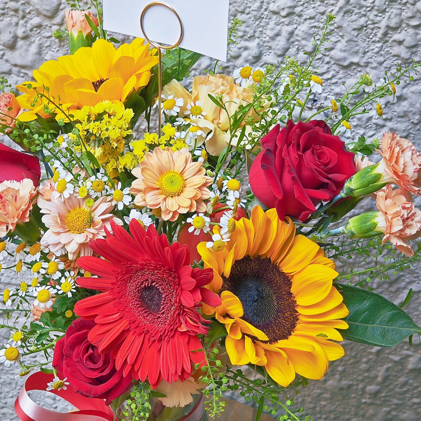 Assorted Red and Orange Flowers in Large Vase Arrangement