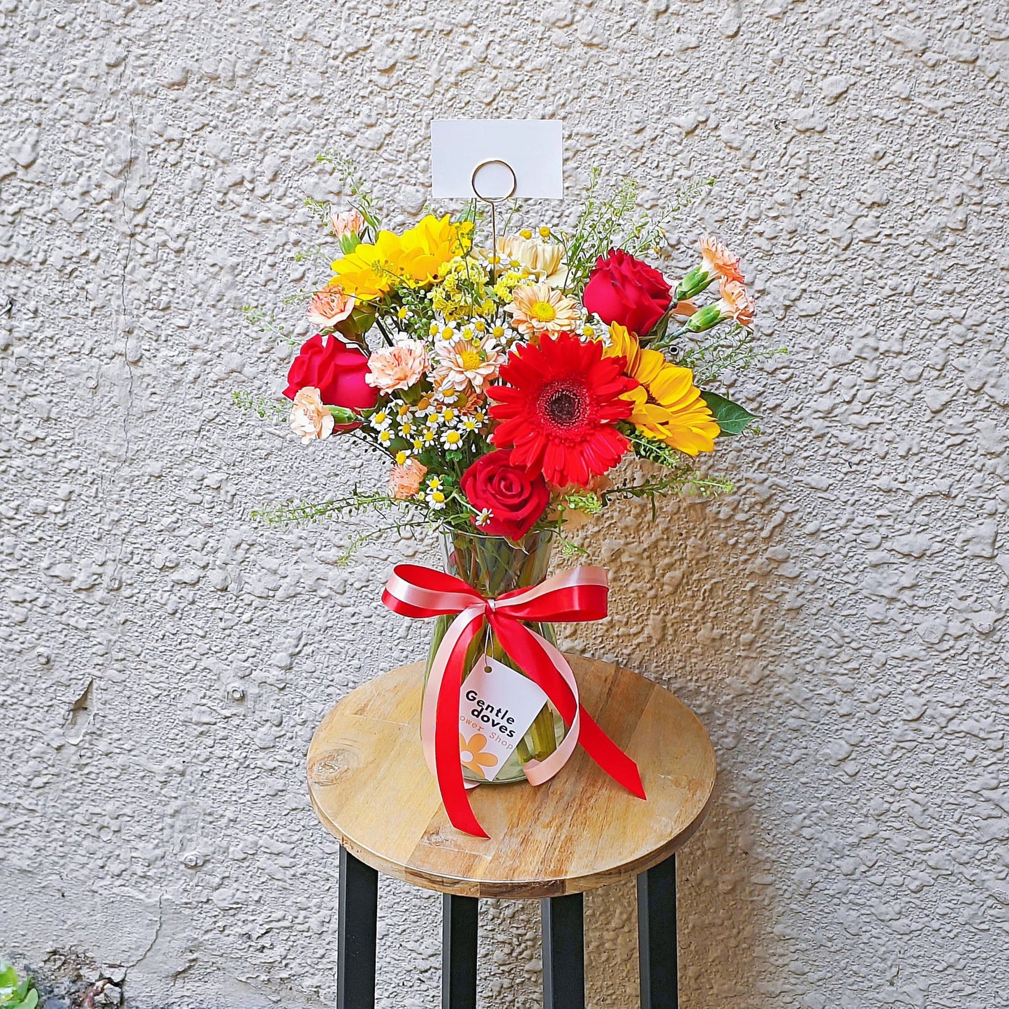 Assorted Red and Orange Flowers in Large Vase Arrangement