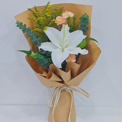 Single White Lily with Sprayed Carnations and Green Foliage in Kraft Paper Small Bouquet