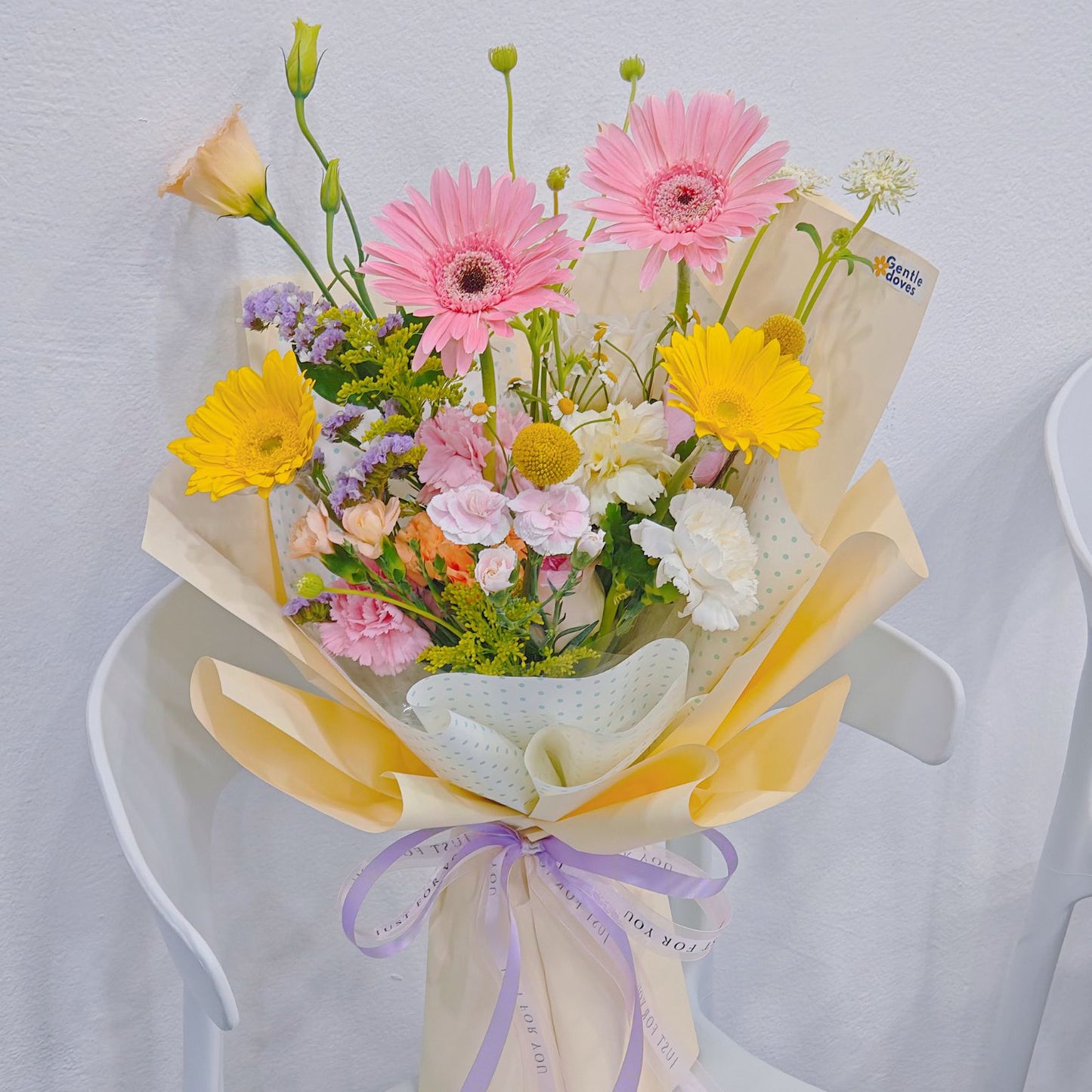 Assorted Pastel and Colorful Flowers in Soft Yellow Bouquet