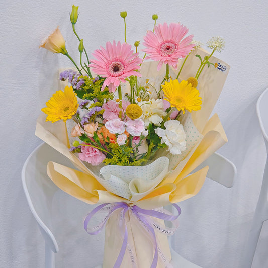 Assorted Pastel and Colorful Flowers in Soft Yellow Bouquet