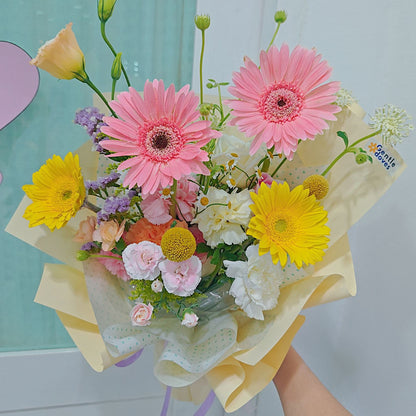 Assorted Pastel and Colorful Flowers in Soft Yellow Bouquet