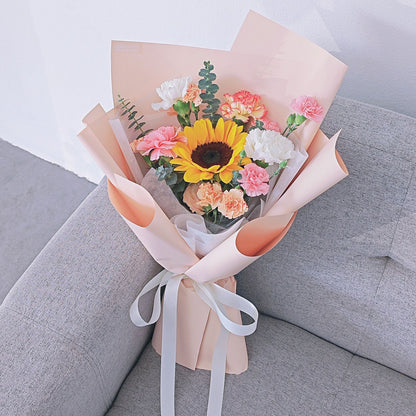 Sunflower with Assorted Soft Color Carnations in Peach Color Paper Bouquet