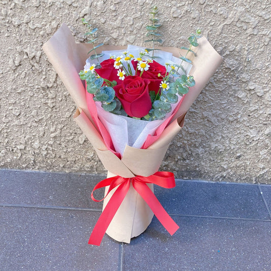 Three Red Roses with Daisies and Eucalyptus in Craft Paper Bouquet