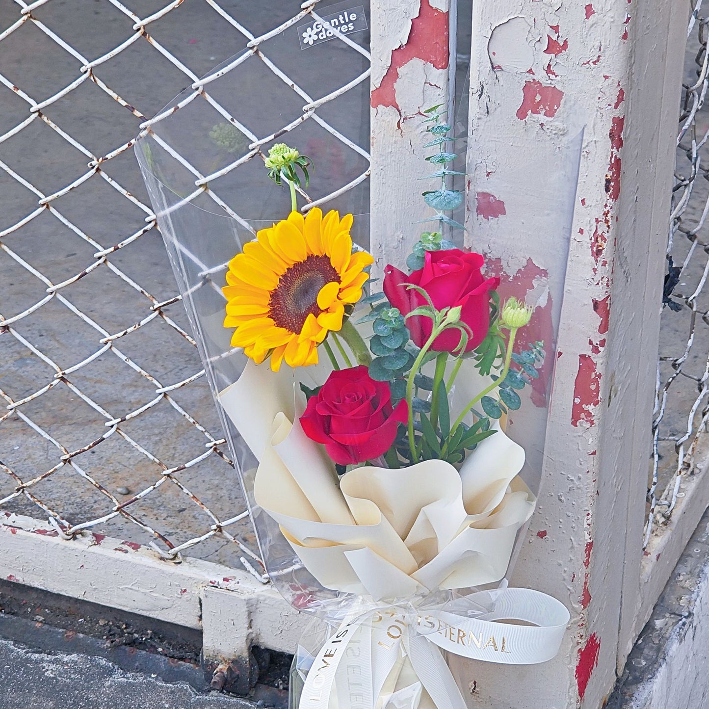 Single Sunflower with Two Red Roses and Green Foliage Minimal Small Bouquet