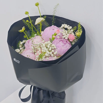Five Soft Pink Peonies with Assorted Pink Flowers and Foliage in Black Paper Bouquet