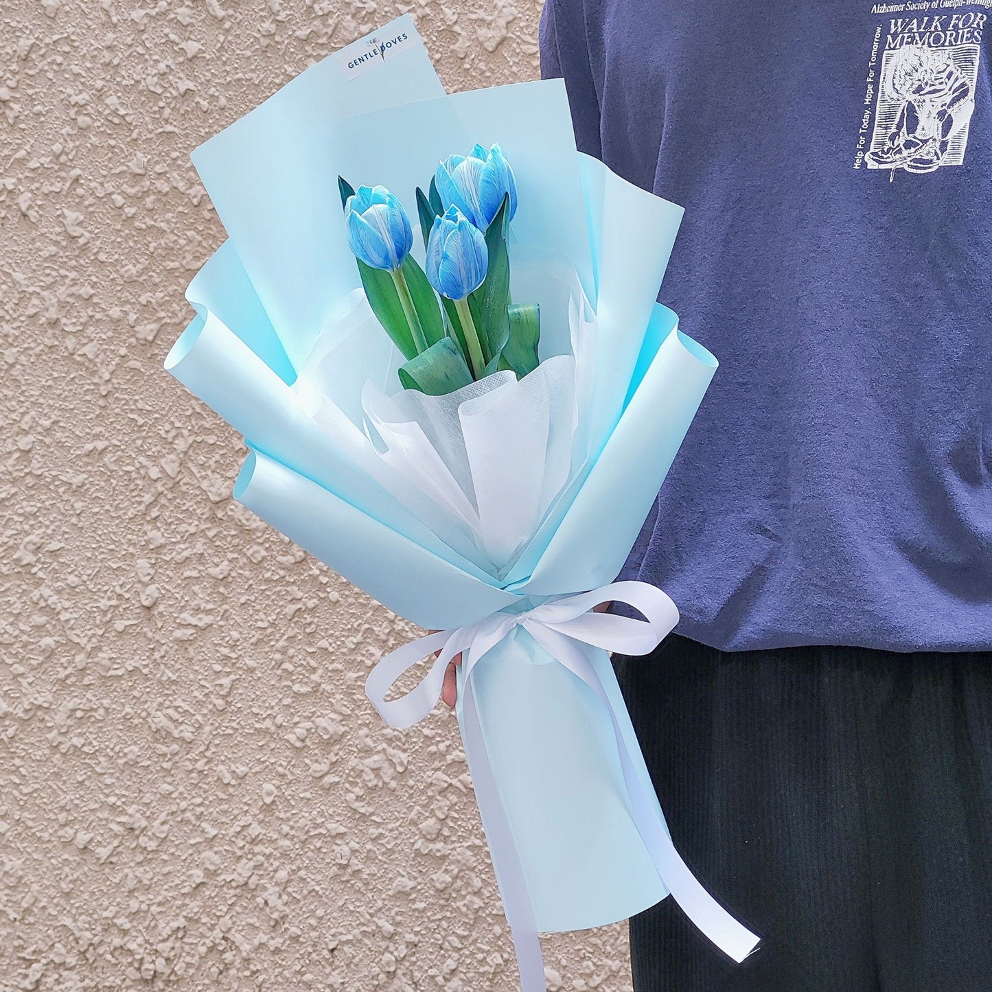 Three Dyed Blue Tulips in Soft Blue Paper Bouquet