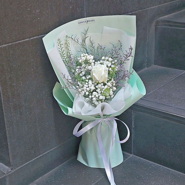 Single White Rose with White and Green Foliage in Mint Paper Bouquet