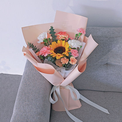 Sunflower with Assorted Soft Color Carnations in Peach Color Paper Bouquet