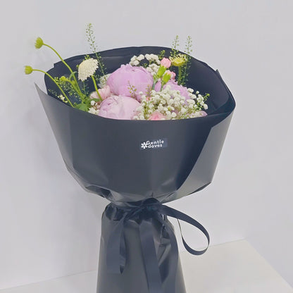 Five Soft Pink Peonies with Assorted Pink Flowers and Foliage in Black Paper Bouquet