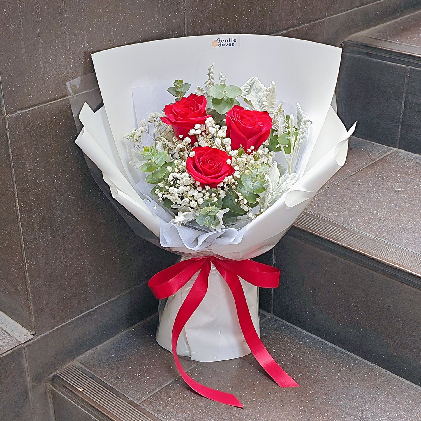 Three Imported Red Roses with Gypsophila, Eucalpytus and Dusty Millers Bouquet