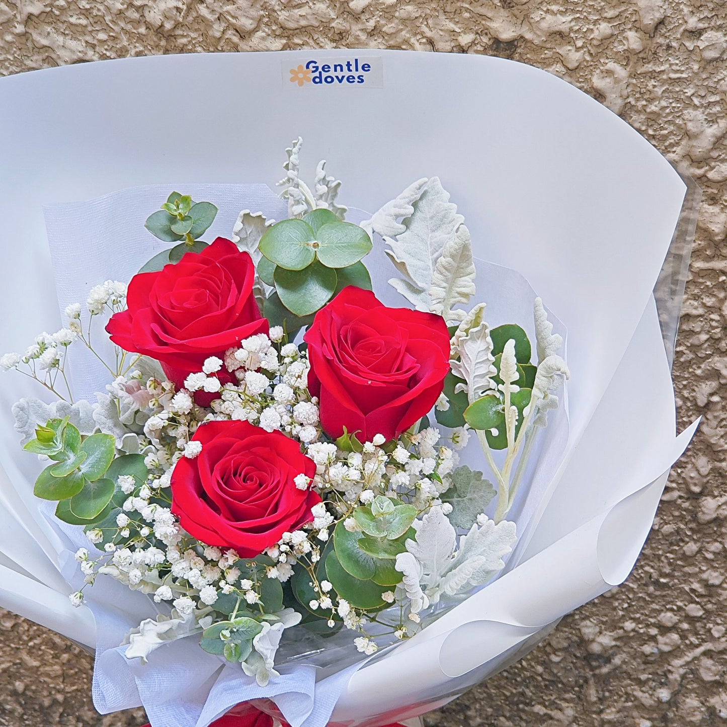 Three Imported Red Roses with Gypsophila, Eucalpytus and Dusty Millers Bouquet