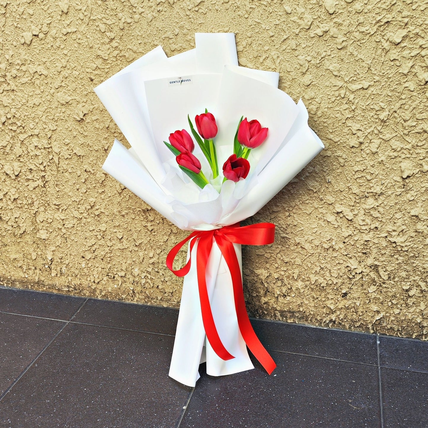 Five Red Tulips in White Paper Bouquet