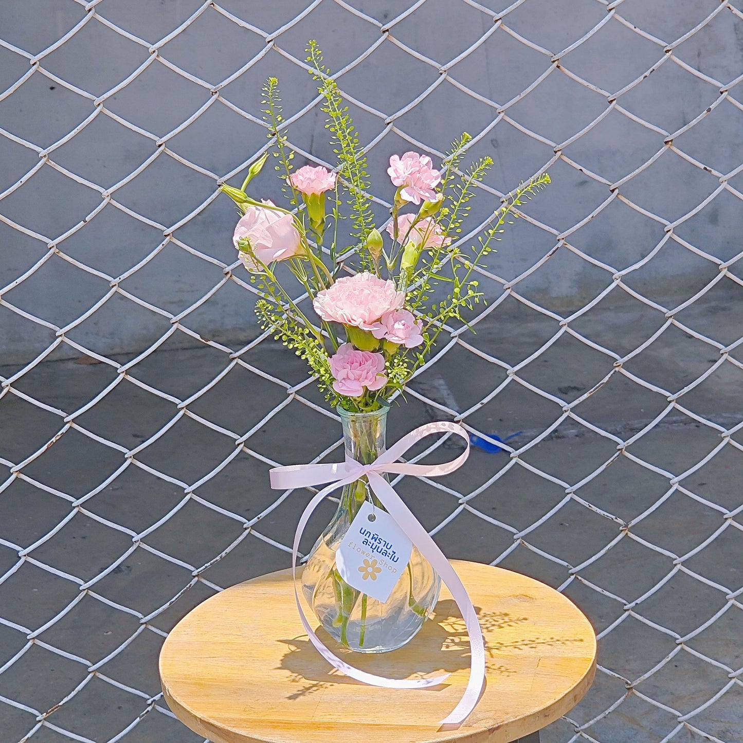 Assorted Pink Flowers with Green Foliage in Small Vase Arrangement