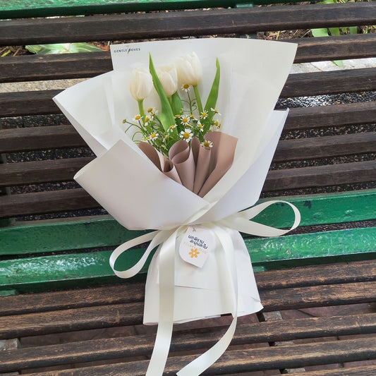 Three White Tulips with Daisies in White Paper Bouquet