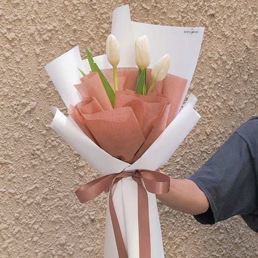 Three White Tulips in Brown and White Paper Bouquet